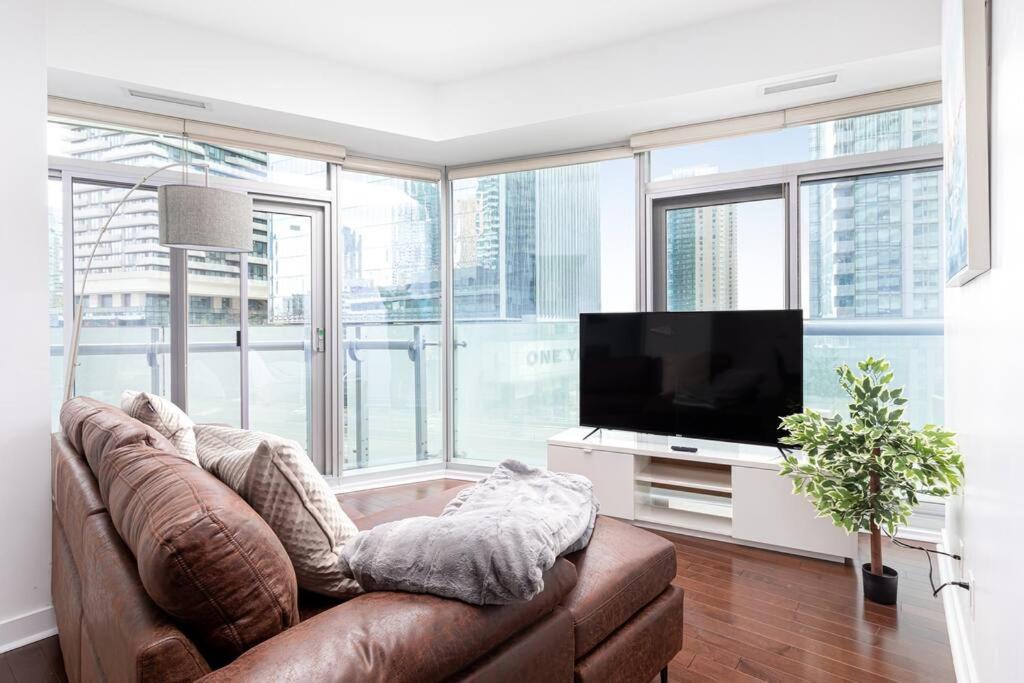 a living room with a couch and a flat screen tv at 2 bedrooms Condo Downtown Toronto with parking in Toronto