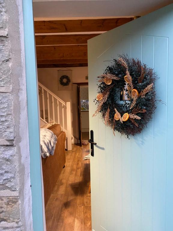 a door leading to a hallway with a wreath on it at Hideaway Cottage in Whitby