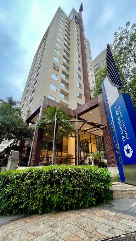 a large building with a sign in front of it at Suíte Transamerica Executive Paulista in Sao Paulo