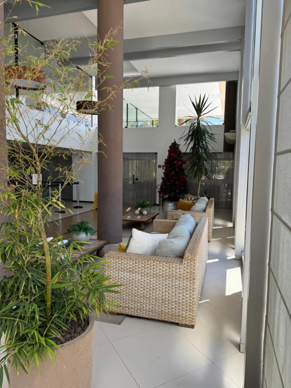 a patio with couches and a christmas tree in the background at Apartamento em Barra Bali, Resort de Luxo, Barra de São de Miguel - 223 in Barra de São Miguel