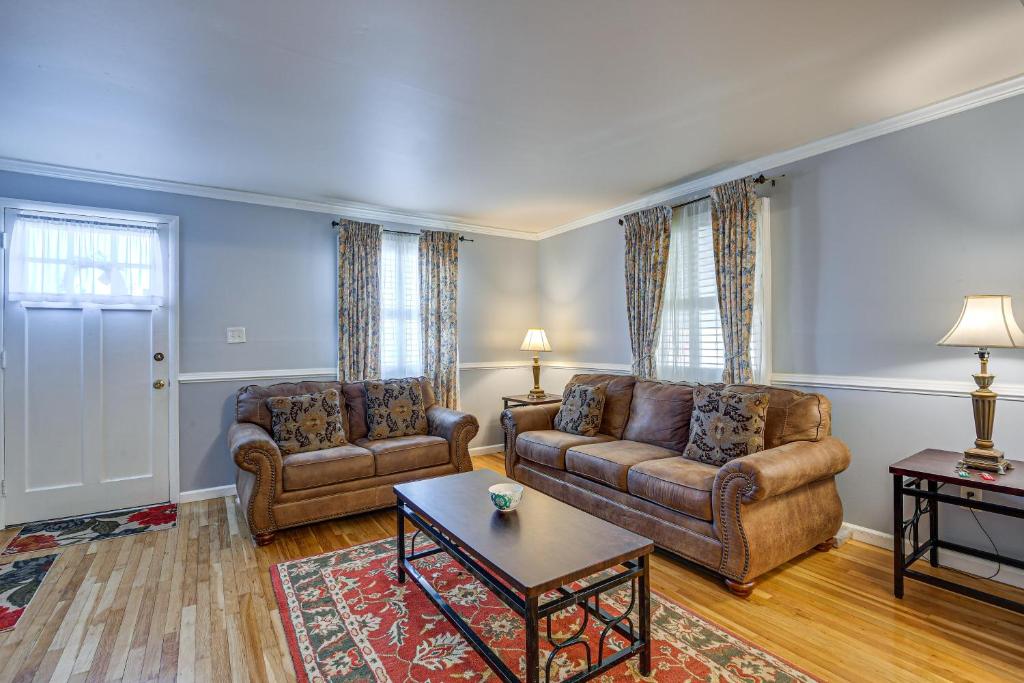 a living room with two couches and a coffee table at Maryland Abode with Patio Near Baltimore Harbor in Baltimore