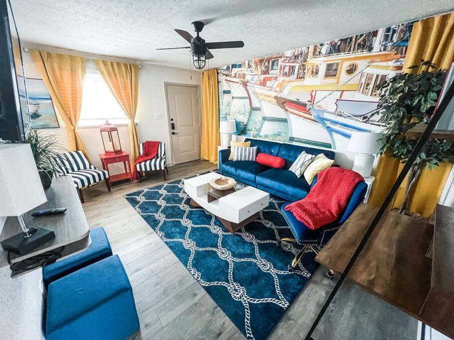 a living room with a blue couch and a blue rug at Nautical Retreat (Unit 5) in Galveston