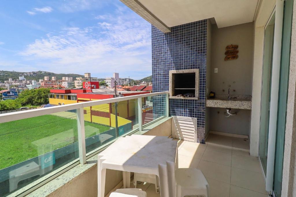 a balcony with a table and a view of a city at 377 - Belissimo apartamento na praia de Bombas in Bombinhas