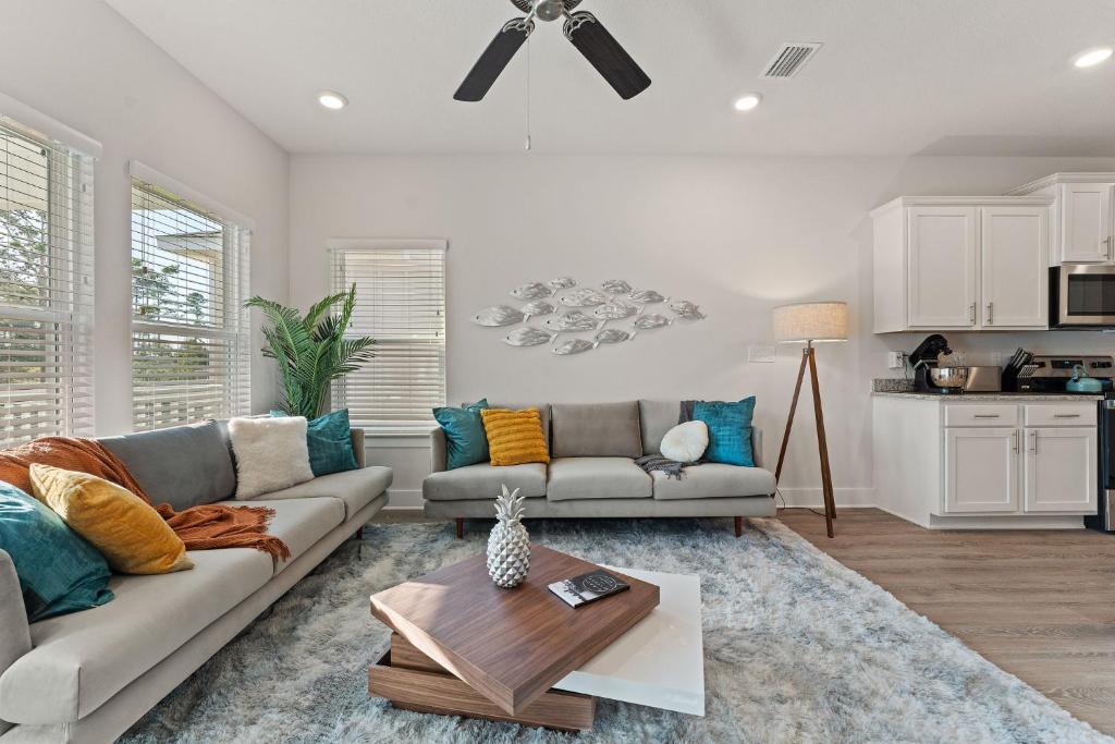 a living room with a couch and a table at Mins to the Beach/King Beds/Arcade-Snowbird Deals! in Perdido Key