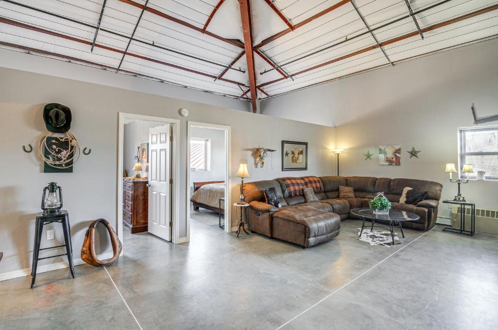 a living room with a couch and a table at Downtown Del Norte Apartment Ski, Hike and Shop! in Del Norte