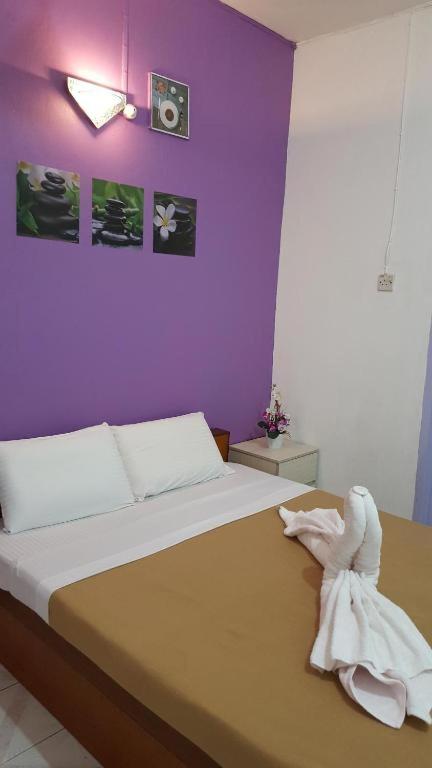 Postel nebo postele na pokoji v ubytování New Orchid Hotel Tuaran
