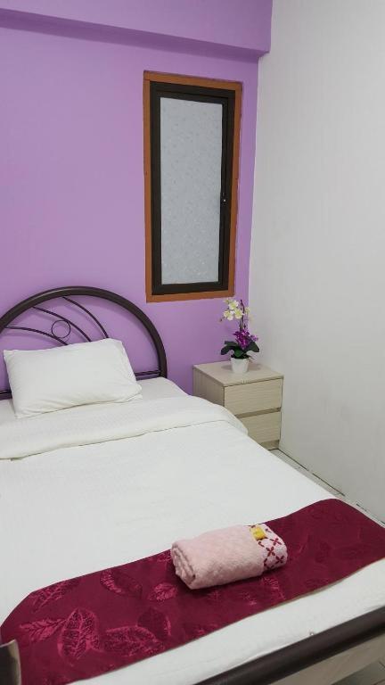 Postel nebo postele na pokoji v ubytování New Orchid Hotel Tuaran