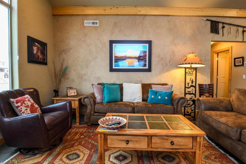 a living room with couches and a coffee table at Rim Village I1 in Moab