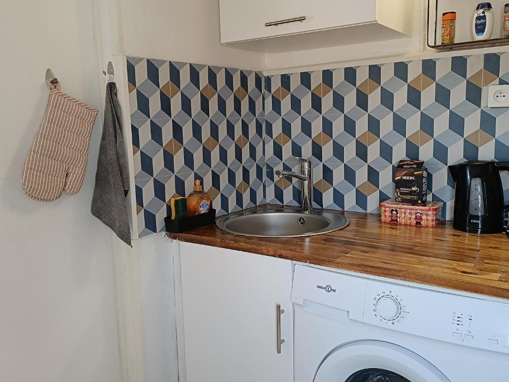 eine Küche mit einer Spüle und einer Waschmaschine in der Unterkunft 29 Rue Mellaise, Appartement 3 pièces in Niort
