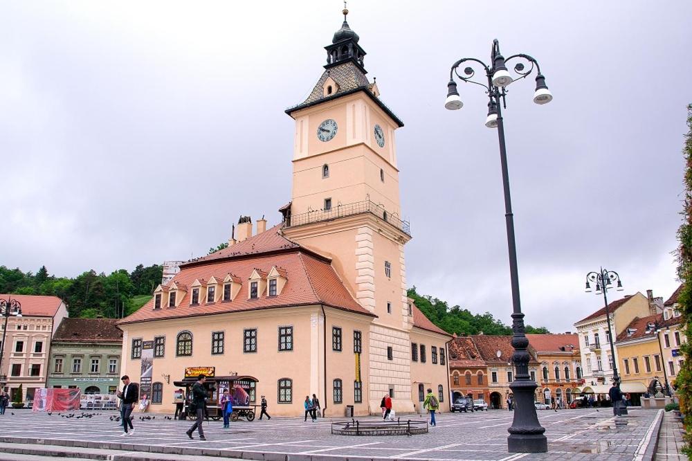 a large building with a clock tower on top of it at Stone Residence in Braşov