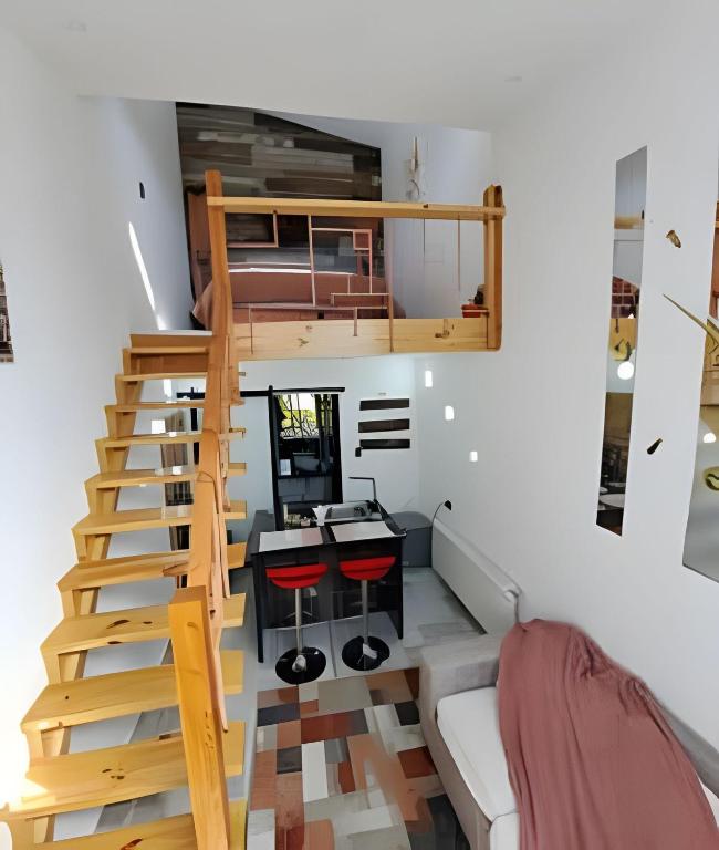 a loft apartment with a staircase and a living room at Okeyloft Coyhaique 4 in Coihaique