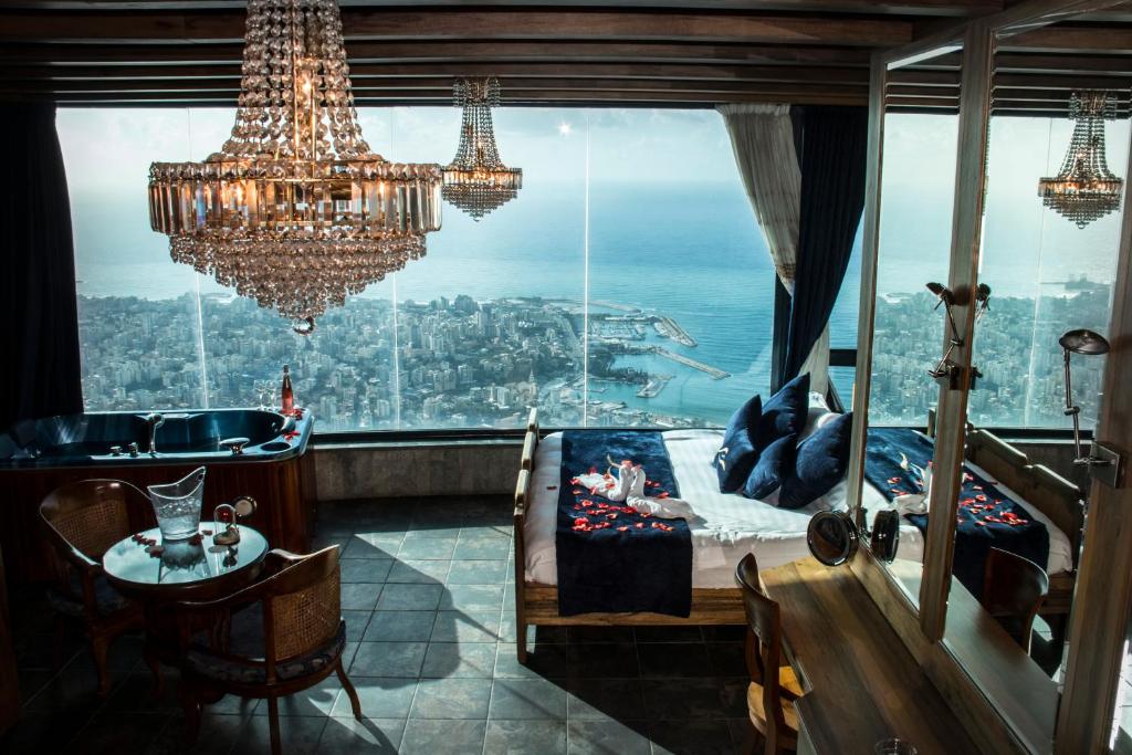 a room with a chandelier and a view of the city at Bay Lodge Boutique Hotel in Jounieh