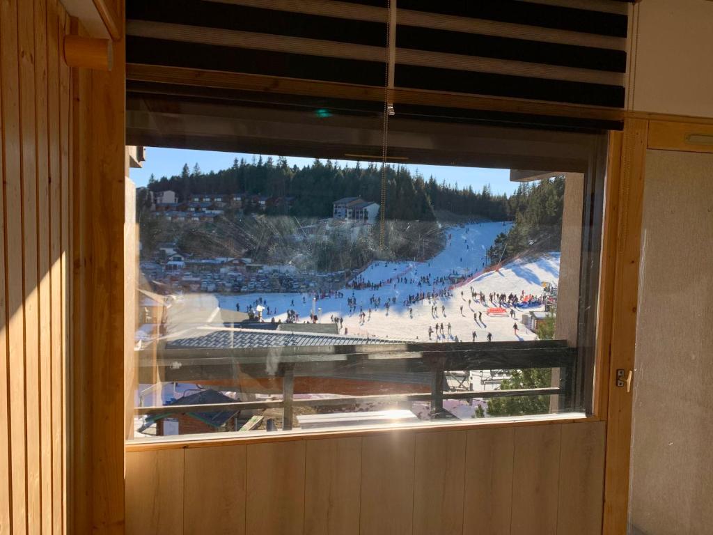 a window with a view of a beach with people at Studio Cabine Chaleureux 4 Personnes Pied des Pistes Pyrénées 2000 in Bolquere Pyrenees 2000