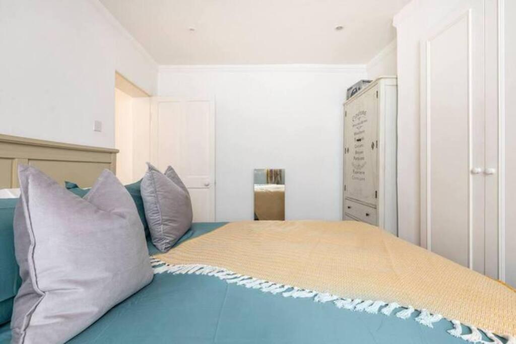 ein Schlafzimmer mit einem Bett mit Kissen darauf in der Unterkunft Affordable, Secluded Flat in Central London in London