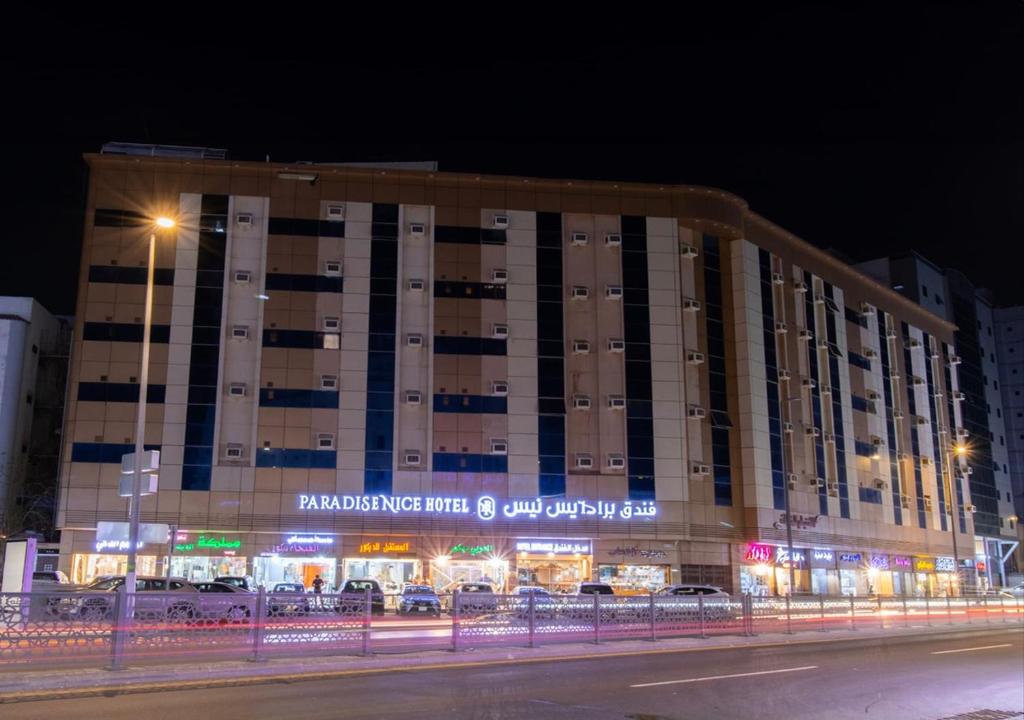 a large building with a sign on the side of it at فندق برادايس نيس النزهة Paradise Nice Hotel in Mecca