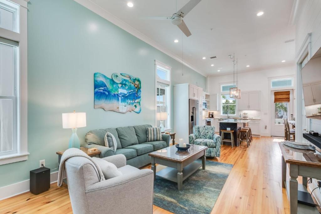 a living room with a couch and a table at Beach Village Resort By Liquid Life in Gulf Shores