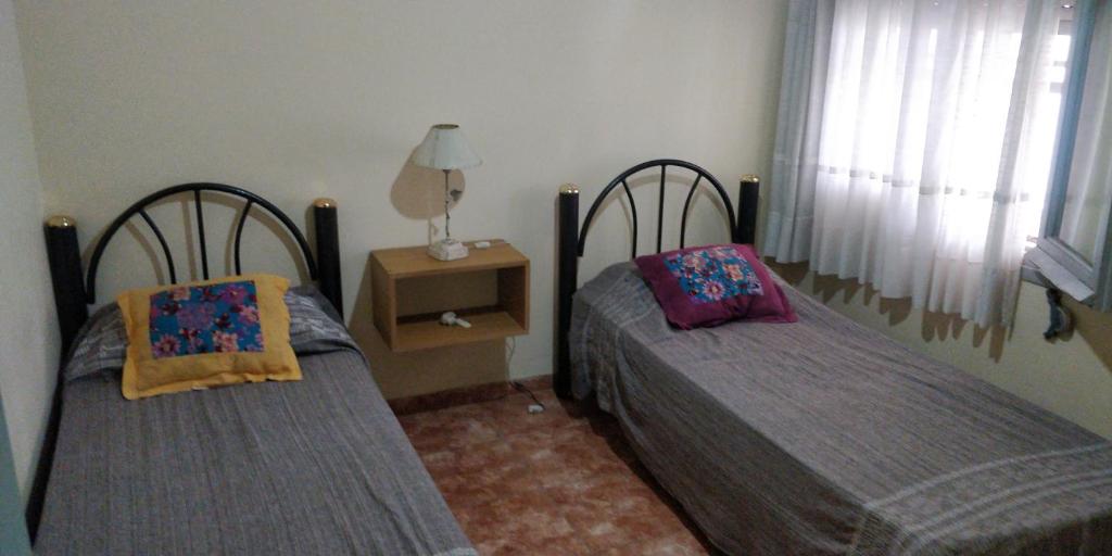 מיטה או מיטות בחדר ב-Casa en Carlos Paz