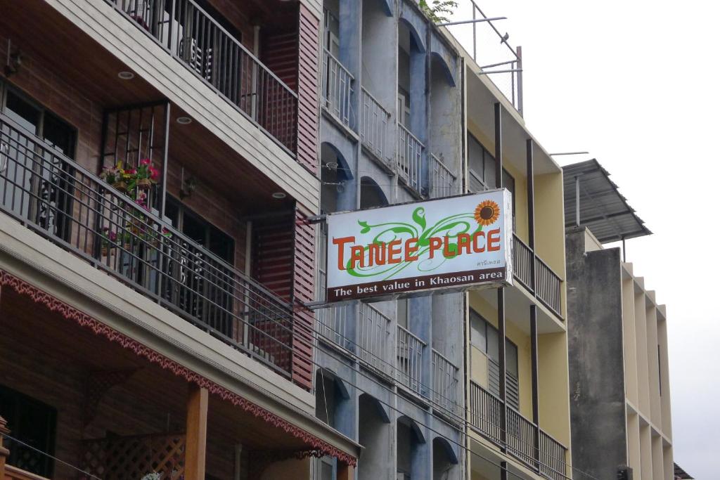a sign on the side of a building at Tanee Place in Bangkok