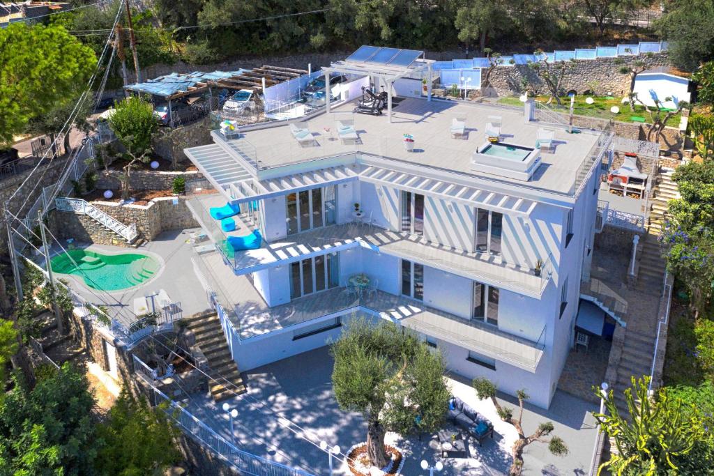 an aerial view of a blue house with a swimming pool at Villa by the beach with sea-view and Luxury amenities in Nerano
