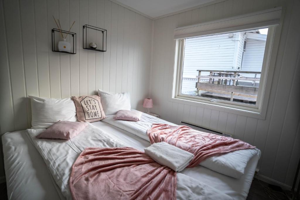 a bedroom with two beds and a window at City Center Getaway 9 by Berti in Stavanger