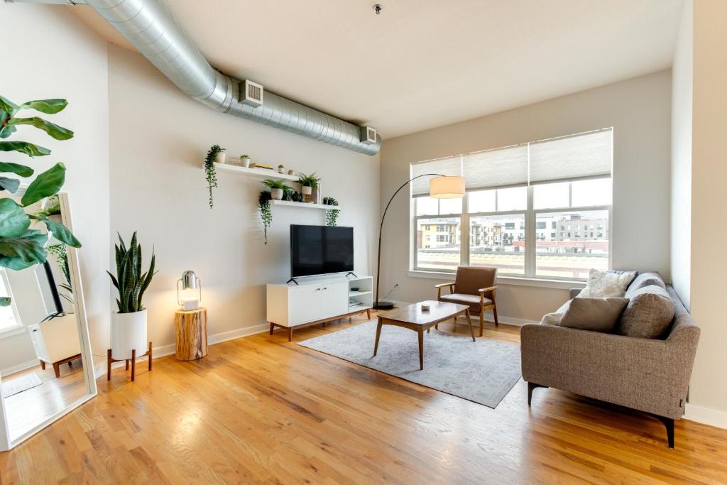 a living room with a couch and a tv at LoHi Condo with Balcony 1 Mi to Downtown Denver! in Denver