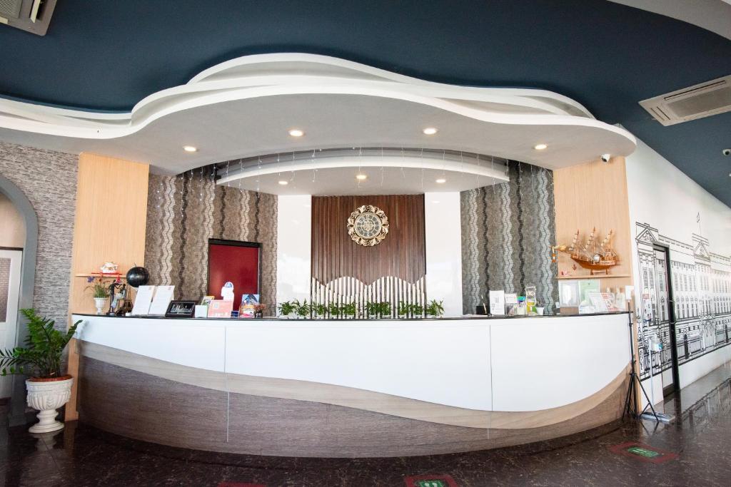 a lobby with a reception desk in a building at The Proud Hotel in Ubon Ratchathani