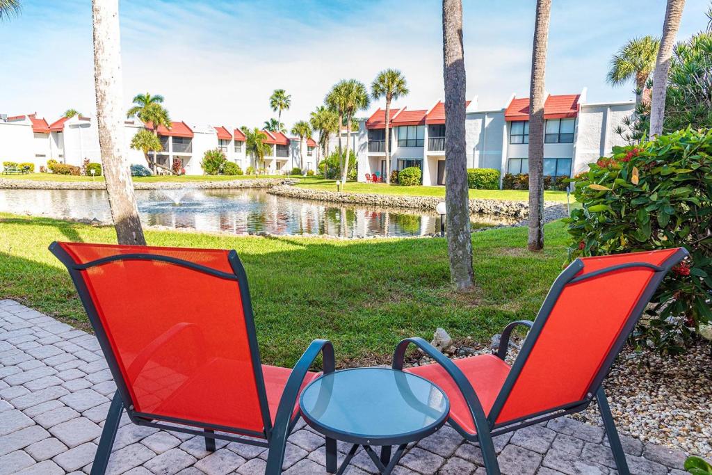 two chairs and a table in front of a building at Runaway Bay in Bradenton Beach