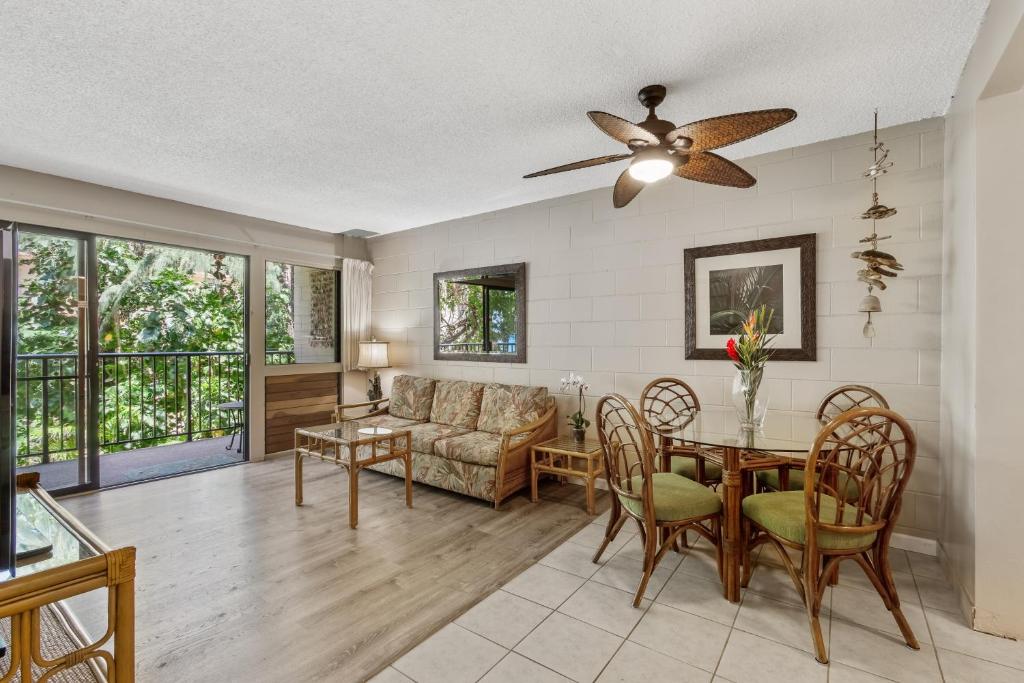 a living room with a table and a couch at Hono Kai B17 in Wailuku