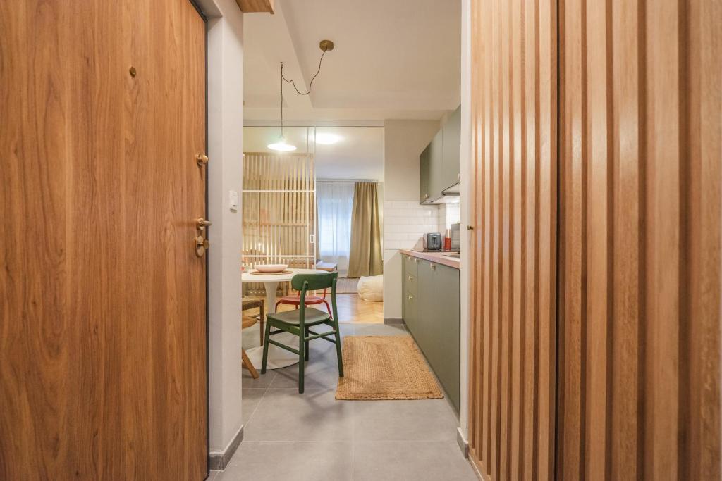 a kitchen with a table and a chair in a room at GREENKO Apartment in Zagreb