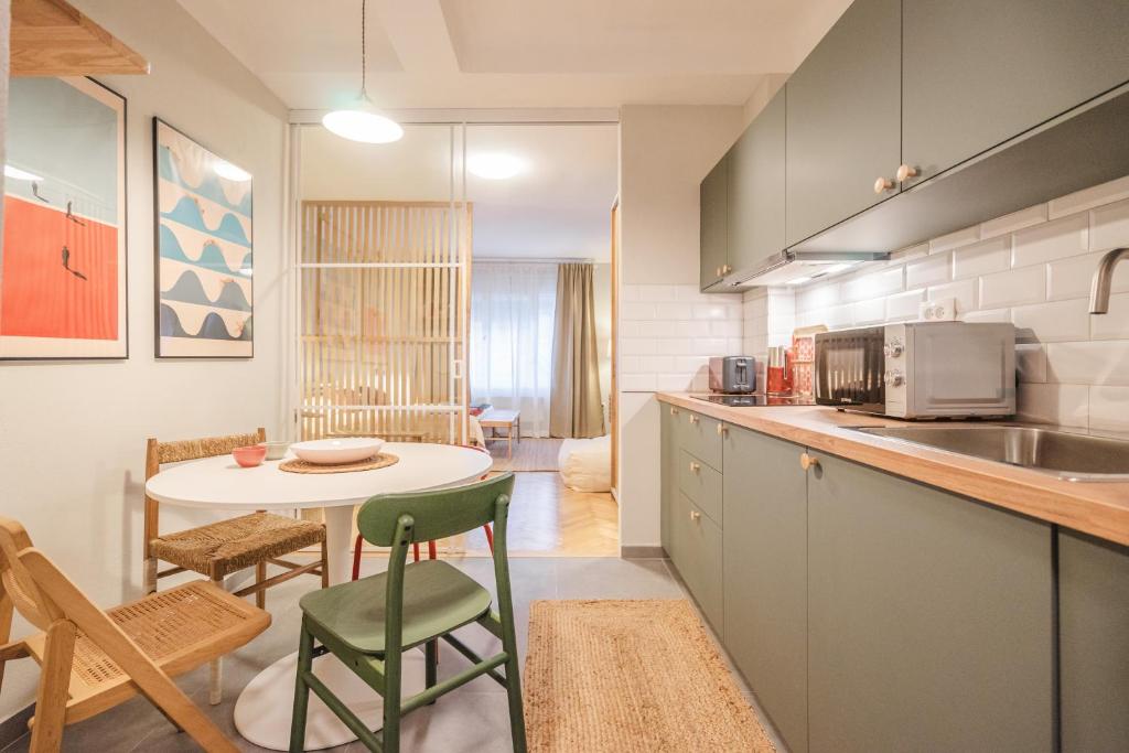 a kitchen with a table and a small kitchen with a dining room at GREENKO Apartment in Zagreb