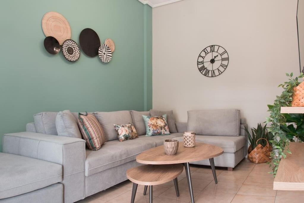 a living room with a couch and a table at Virginia's Luxury Suites 2 in Volos