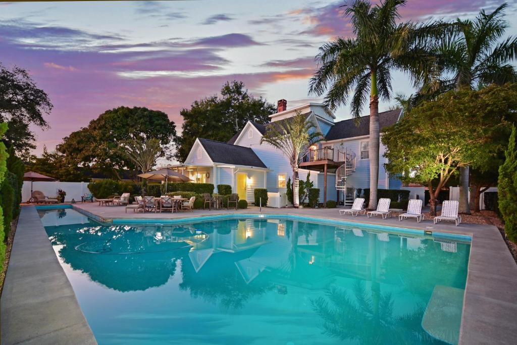 a swimming pool in front of a house at The Gathering Place in Bradenton