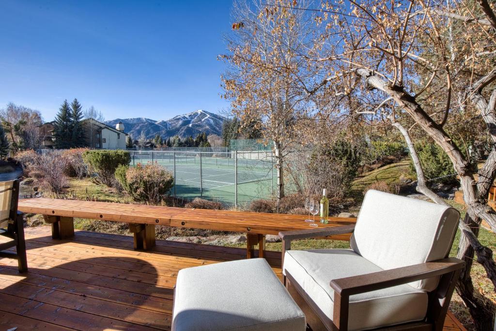 a patio with a table and chairs and a tennis court at Wildflower Resort Stay - Sun Valley Condo with King Bed and Mtn Views in Sun Valley