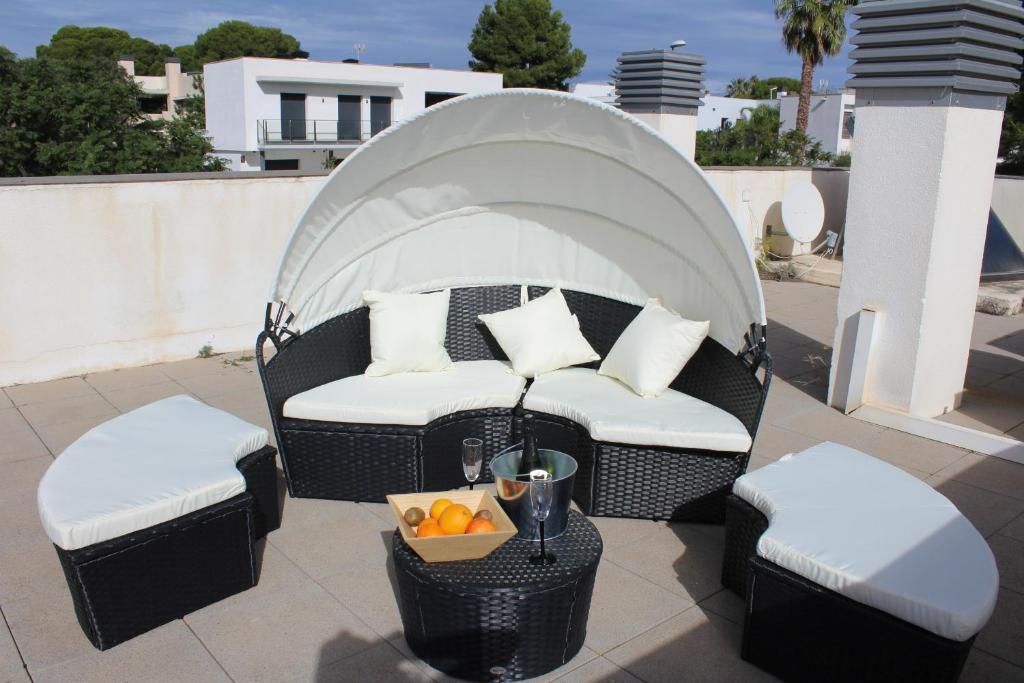 a gazebo with a couch and a bowl of fruit at Residentium Spain -Chalet la Dorada pets friendly in Cambrils