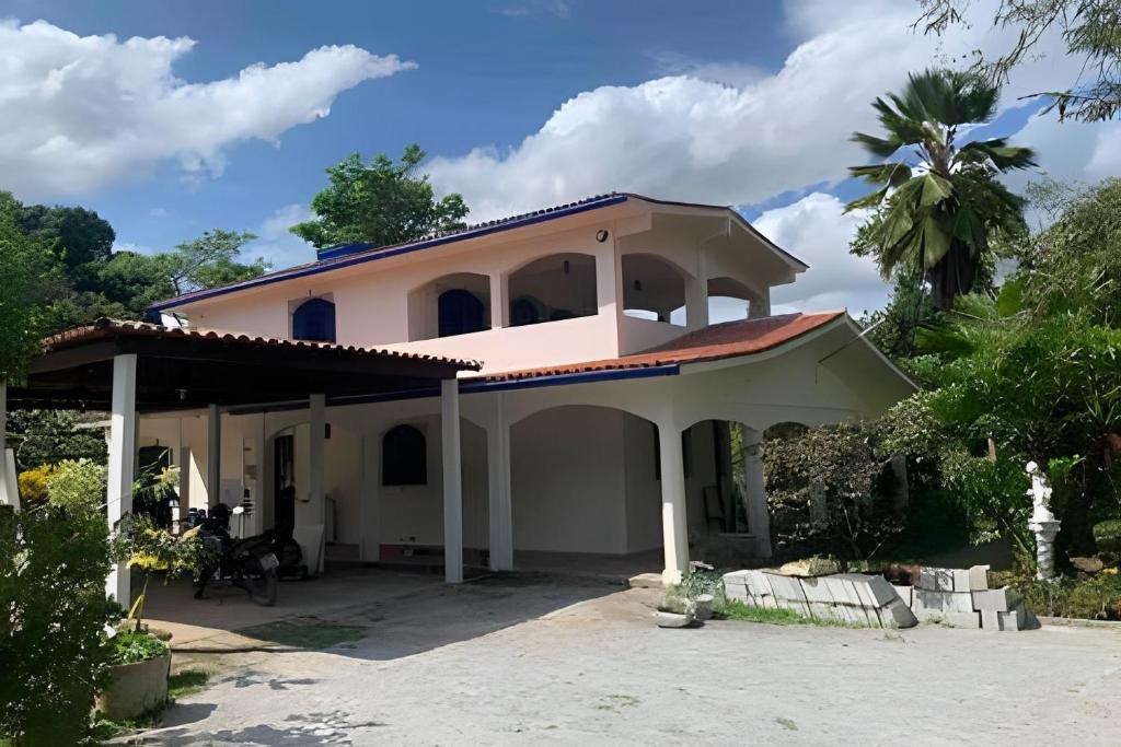 a large white house with a roof at Sítio com Piscina em Aldeia in Camaragibe