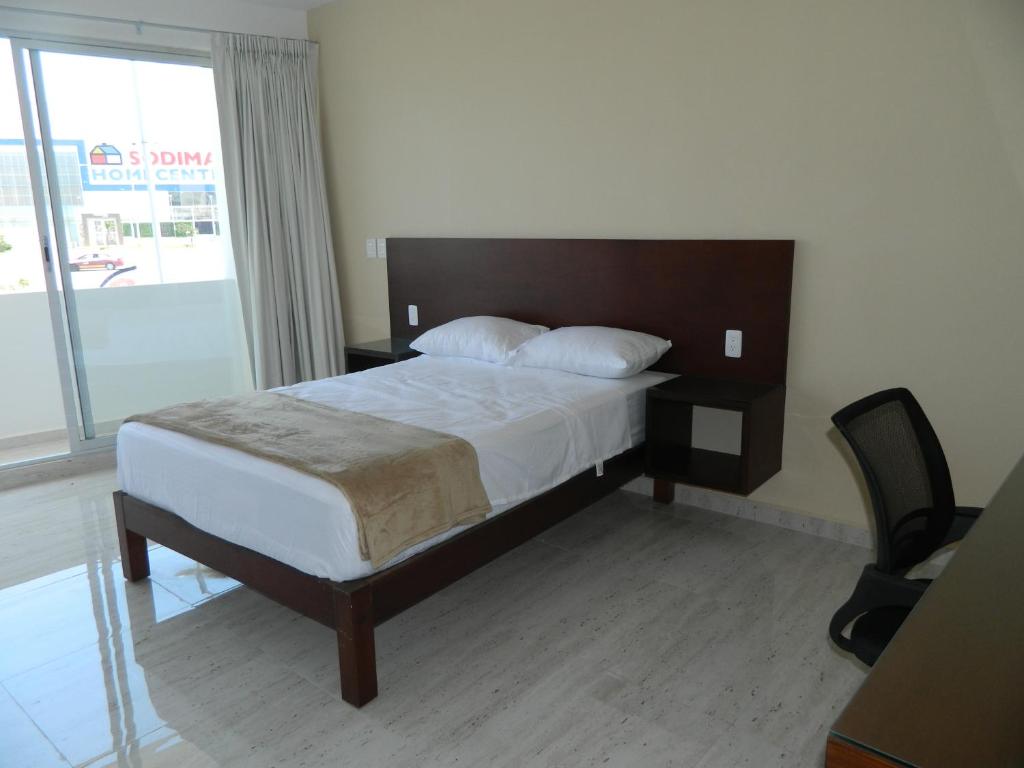 Postel nebo postele na pokoji v ubytování ACL Suites