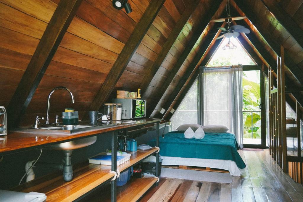 a kitchen with a bed in a room with a window at Toku in Fortuna