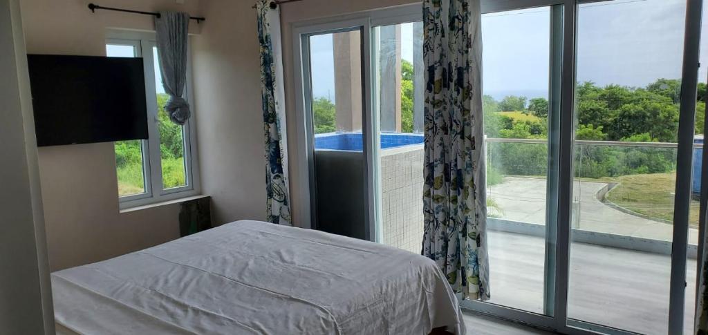 a bedroom with a bed and a large window at TIE-2 bedroom luxury home in La Fargue