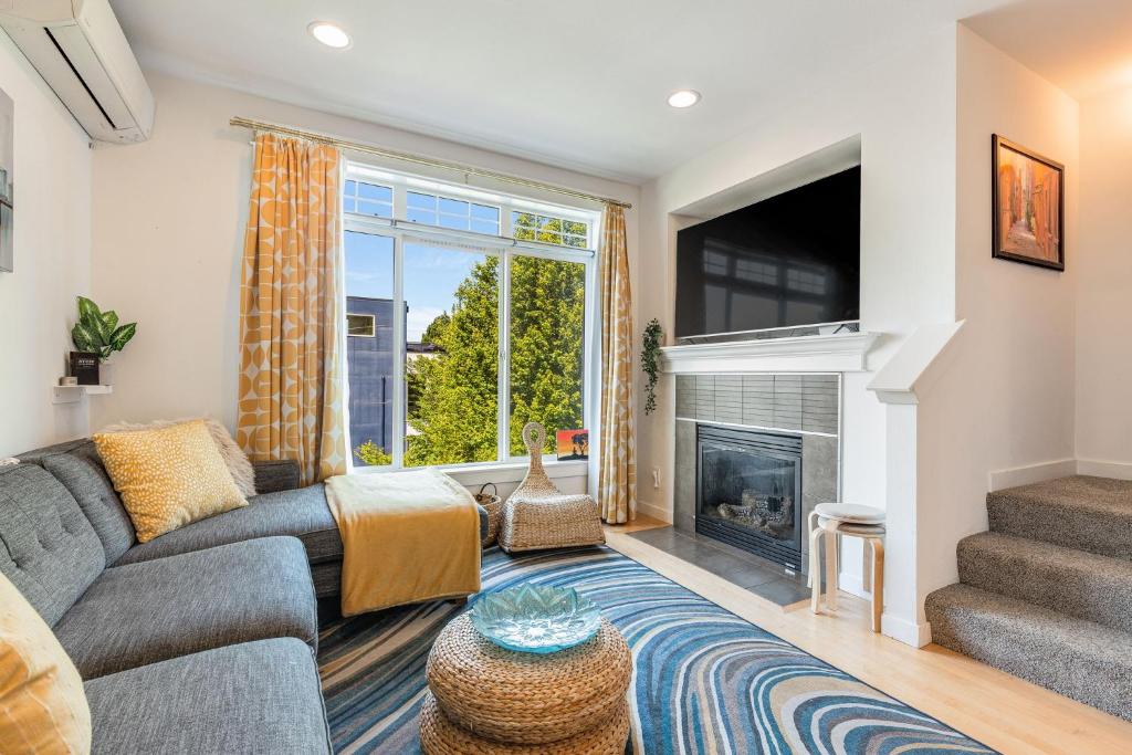 a living room with a couch and a fireplace at Lakeview Charm BY Betterstay in Seattle
