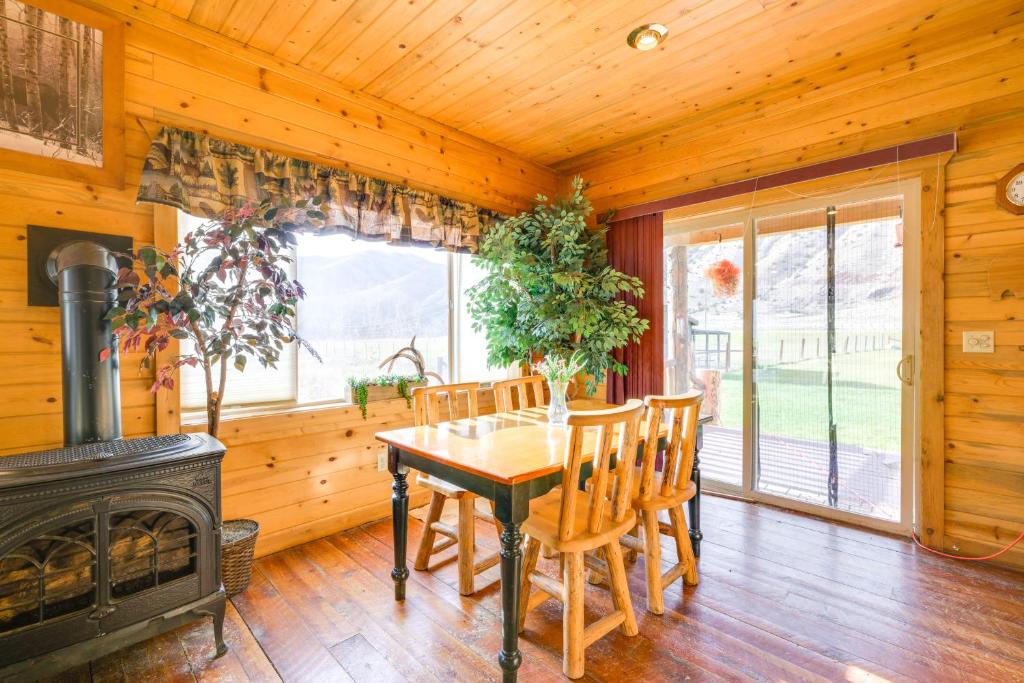 a dining room with a table and a fireplace at Pet-Friendly Idaho Home on the Salmon River! in Salmon