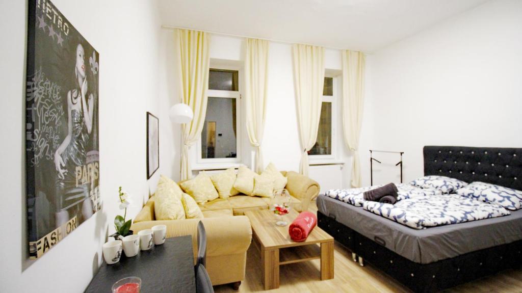 a living room with a couch and a bed at Family apartment in Brigittenau in Vienna
