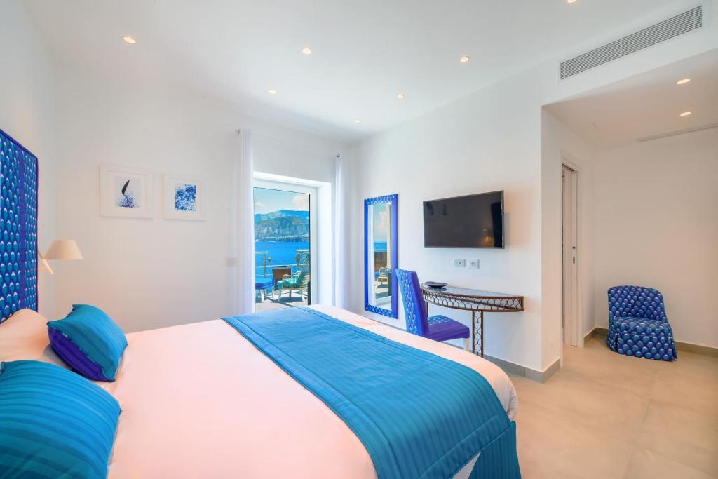 A bed or beds in a room at My Exclusive Italy - Beachfront Villa Sorrento & private sea access