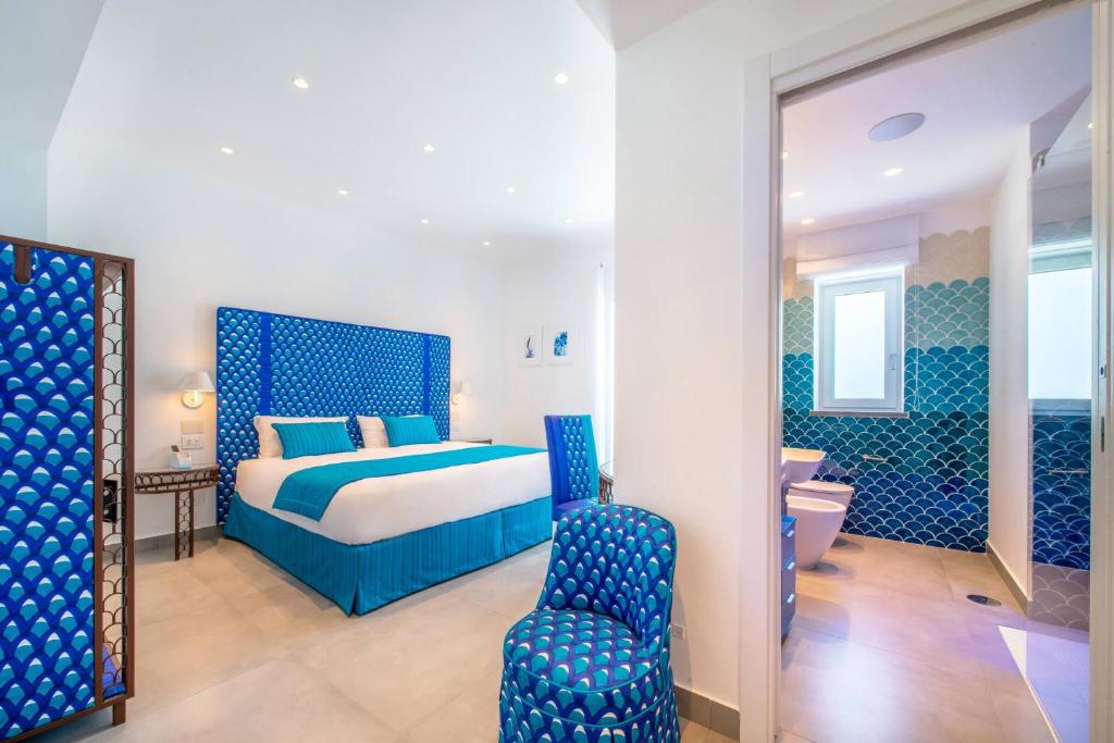 A bed or beds in a room at My Exclusive Italy - Beachfront Villa Sorrento & private sea access