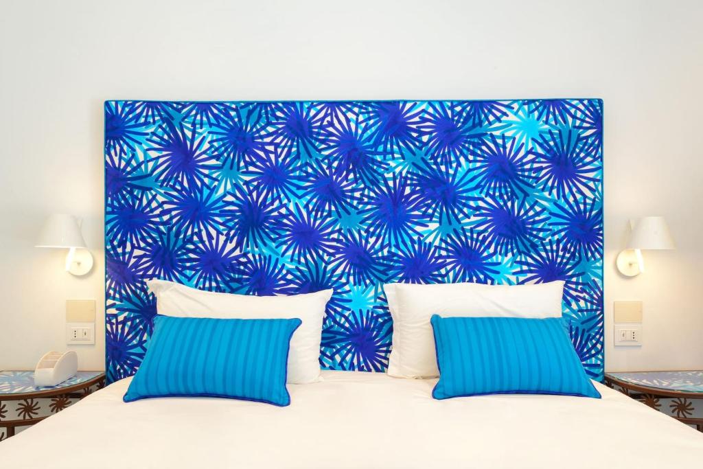 A bed or beds in a room at My Exclusive Italy - Beachfront Villa Sorrento & private sea access