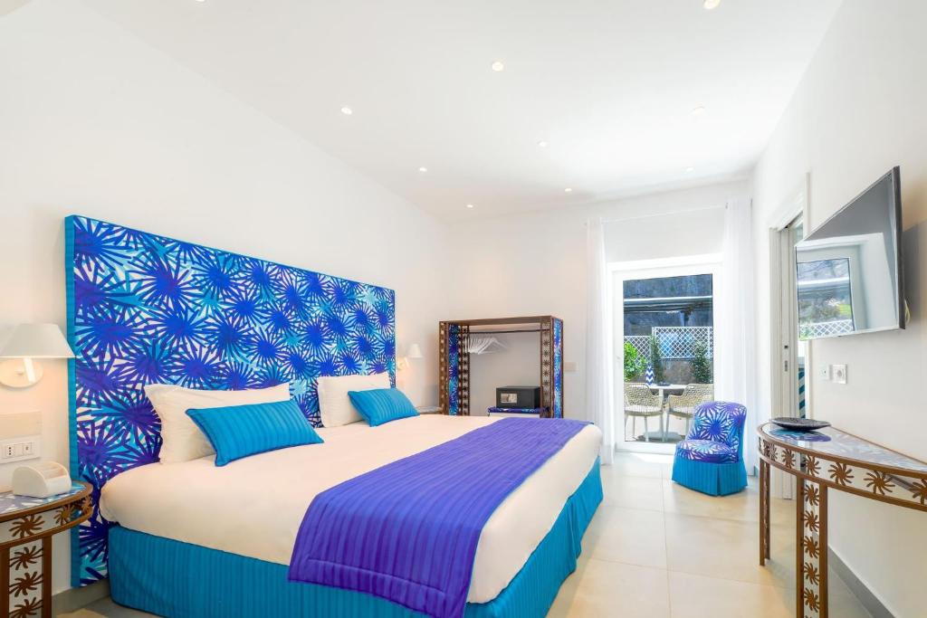 A bed or beds in a room at My Exclusive Italy - Beachfront Villa Sorrento & private sea access