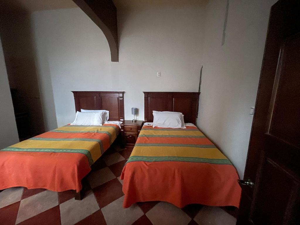 Postel nebo postele na pokoji v ubytování HOTEL PUEBLO GRANDE