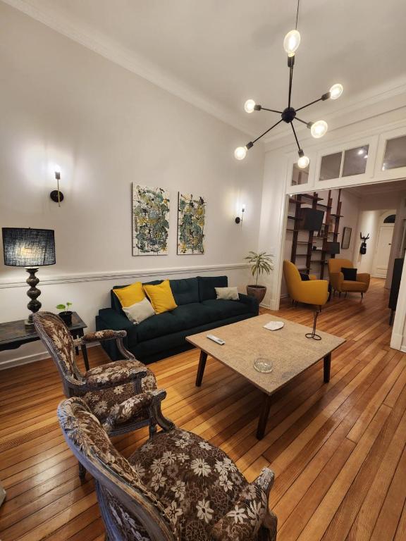 a living room with a couch and a table at Baires Art Decó in Buenos Aires