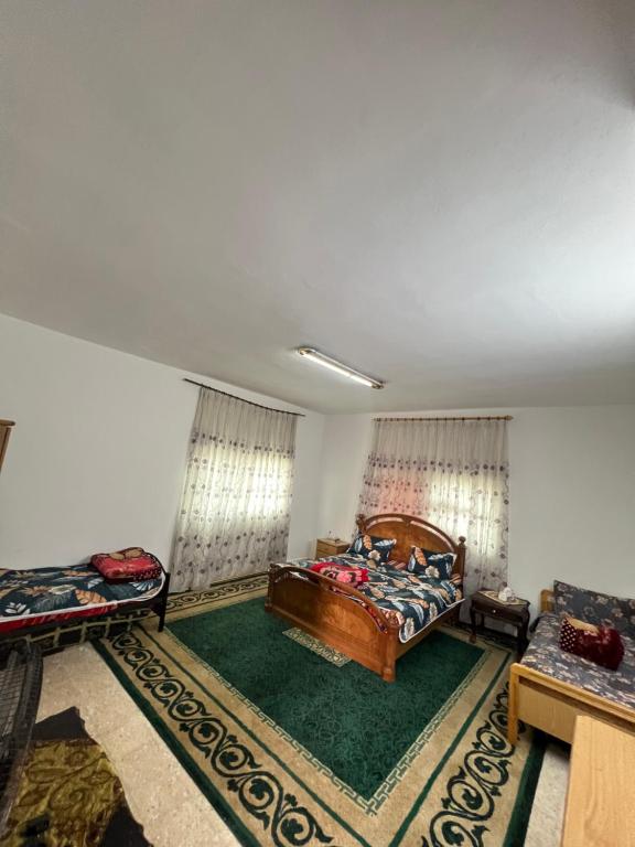 a large room with a bed and a couch at Abuawad Rental in Jerash