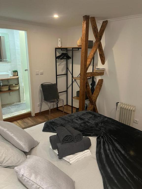 a bedroom with a large bed with black sheets at Alfama authentic Lisbon in Lisbon