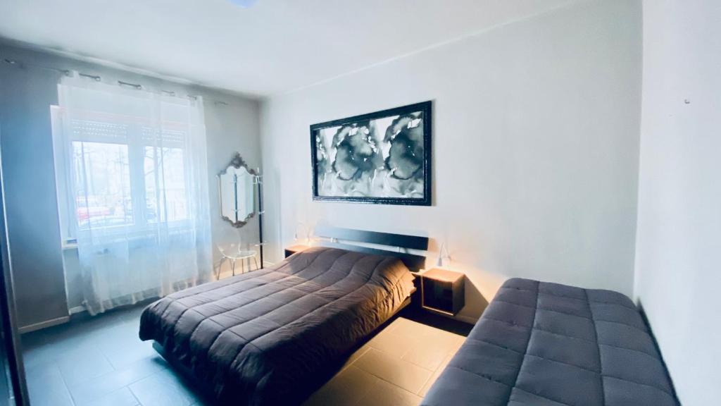 a bedroom with a bed and a window in it at Miraflowers Home in Turin